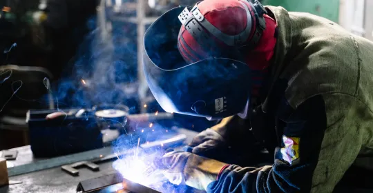 Welder welding metal